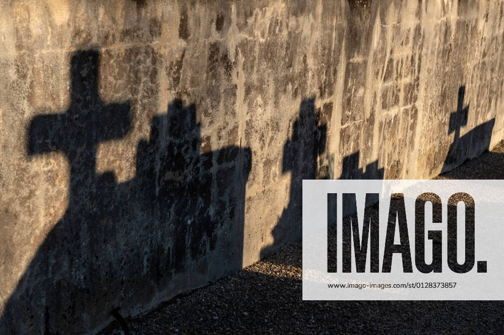 Silhouettes of crosses Eauze (south western France): shadows of crosses from the cemetery on the wall of the rural Church of Saint Amand Occitanie Pyrenees Mediterranee; Midi Pyrenees; Gers 32 Europe; Western Europe; France