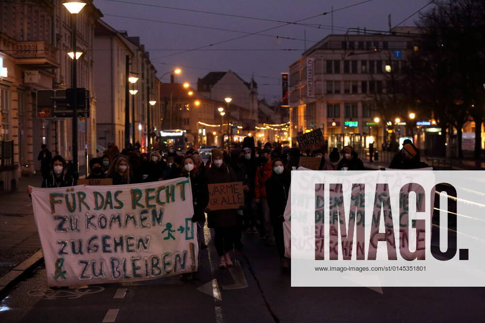 Protesters walk with banners in Friedrich Ebert street during a sea bridge demonstration for the reception of refugees from the Polish-Belarusian border area, Potsdam, 18 December 2021 sea bridge demo in Potsdam