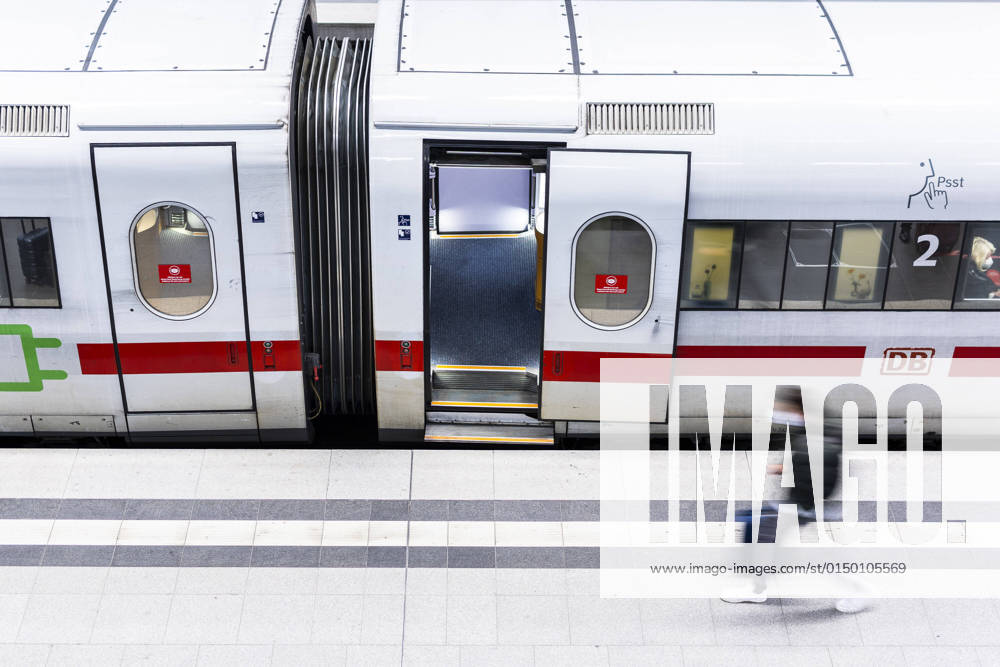 A person with suitcase draws off in front of a standing Deutsche Bahn ICE train in Berlin main station, 07 02 2022 Berlin Germany