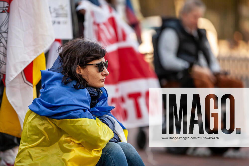 Belarusian opposition leader Sviatlana Tsikhanouskaya attends Ukraine protest A protester wearing a Ukrainian flag listens to a speech during a rally at the White House against Russia s war in Ukraine. The Belarusian community in the Washington, DC metro area joined US Ukrainian Activists daily protest at the White House to show their support. Both countries currently suffer at the hands of Russian President Vladimir Putin: Ukraine is under attack, and Belarus is led by Putin puppet Alexander Lukashenko. Washington DC United States