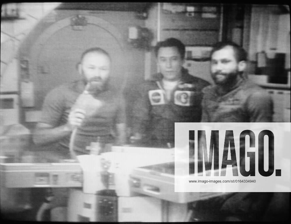S73-38962 (28 Dec. 1973) --- The three members of the Skylab 4 crew confer via television communication with Dr. Lubos Kohoutek, discoverer of the Comet Kohoutek. This picture of the three astronauts was reproduced from a TV transmission made by a TV camera aboard the space station in Earth orbit. They are, left to right, Gerald P. Carr, commander; Edward G. Gibson, science pilot; and William R. Pogue, pilot. They are seated in the crew quarters wardroom of the Orbital Workshop. Professor Kohoutek, who is employed at the Hamburg Observatory in West Germany, was visiting the Johnson Space Center in Houston when he conferred with the Skylab 4 crewmen.