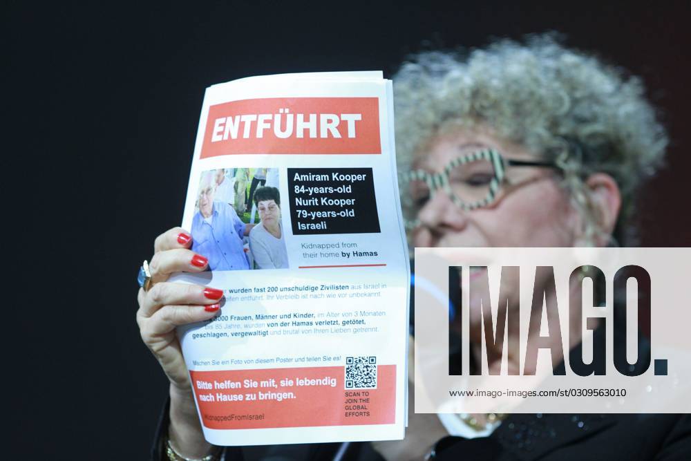 Frankfurt Book Fair 2023 Israeli writer Lizzie Doron holds up a leaflet reading Kidnapped, referring to Amiram Kooper and Nurit Kooper, believed to have been taken hostage by Hamas from Israel to the Gaza Strip