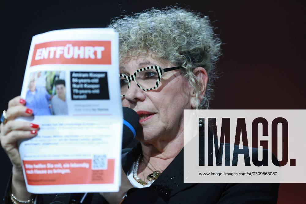 Frankfurt Book Fair 2023 Israeli writer Lizzie Doron holds up a leaflet reading Kidnapped, referring to Amiram Kooper and Nurit Kooper, believed to have been taken hostage by Hamas from Israel to the Gaza Strip