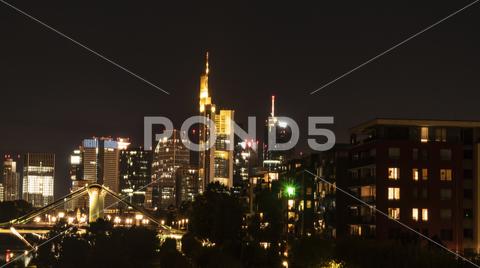 FRANKFURT am MAIN, GERMANY 2019 OCTOBER 05 Illuminated Cityscape Night View Frankfurt am Maine Germany architecture, background, brick, bridge, river, main, building, buildings, business, centre, city, cityscape, dark, downtown, editorial, europe, european, famous, frankfurt, frankfurt am main, mainhattan, germany, illuminated, park, sky, clouds, skyline, hotel, lindner, commerzbank