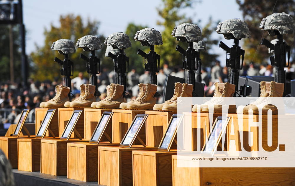 Memorial service for 13 killed and 30 wounded at Fort Hood shooting Fort Hood, TX - November 10, 2009 -- The Soldiers Cross, boots, rifles and helmets, sit on the podium at the memorial service for the 12 soldiers and one civilian killed at Fort Hood U.S Army Post near Killeen, Texas, USA 10 November 2009. Army Major Malik Nadal Hasan reportedly shot and killed 13 people, 12 soldiers and one civilian, and wounded 30 others in a rampage 05 November at the base s Soldier Readiness Center where deploying and returning soldiers undergo medical screenings. .Credit: Tannen Maury Pool via CNP Fort Hood Texas United States of America