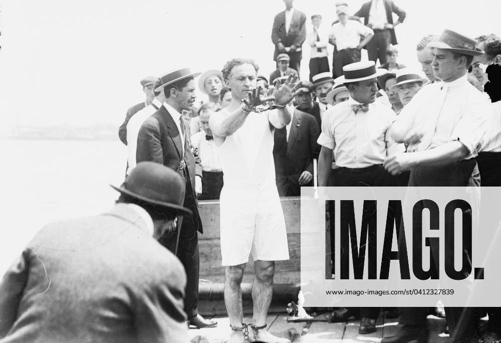Harry Houdini being handcuffed before being nailed into a crate and lowered into New York Bay, 1912 (b w photo) 1766225 Harry Houdini being handcuffed before being nailed into a crate and lowered into New York Bay, 1912 (b w photo); Private Collection; (add.info.: Houdini, born Erik Weisz (1874-1926) in Budapest was nailed into a packing case said to contain iron weights, which he escaped through a trap.).