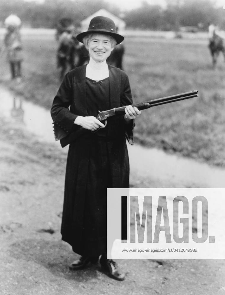 Annie Oakley with the gun Buffalo Bill gave her, 1922 (b w photo) 3247842 Annie Oakley with the gun Buffalo Bill gave her, 1922 (b w photo) by American Photographer, (20th century); Private Collection; (add.info.: Annie Oakley (1860-1926) born Phoebe Ann Moses, worked as sharpshooter in vaudeville, circuses, and Wild West shows, joining Buffalo Bills Wild West in 1885. William Frederick Buffalo Bill Cody (1846-1917) American soldier and showman gave her this Winchester 1873 .44-40 caliber factory-made, smooth bore rifle made in 1892. They both used smooth-bore rifles in the Wild West Show for shooting at aerial targets.).