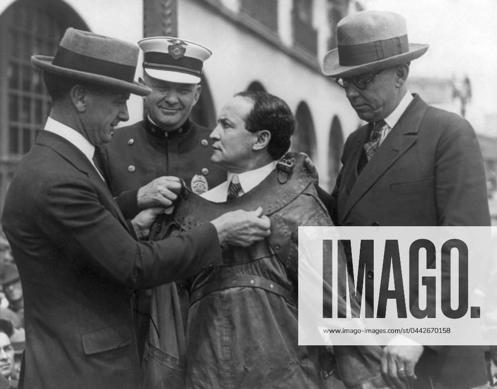 HARRY HOUDINI (1874-1926). American magician. Houdini secured into a strait jacket for an escape. Photograph, c1920.