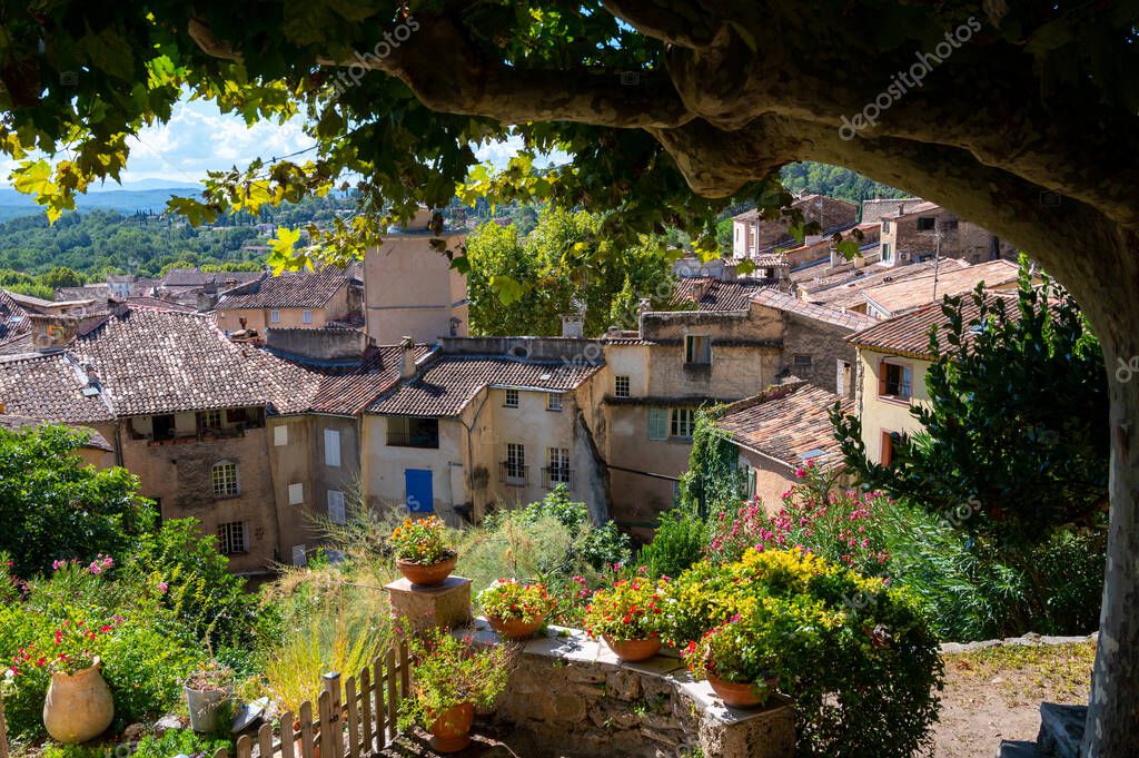 Travel destination, small ancient village Cotignac in Var, Provence, surrounded by vineyards and cliffs with troglodytes houses.