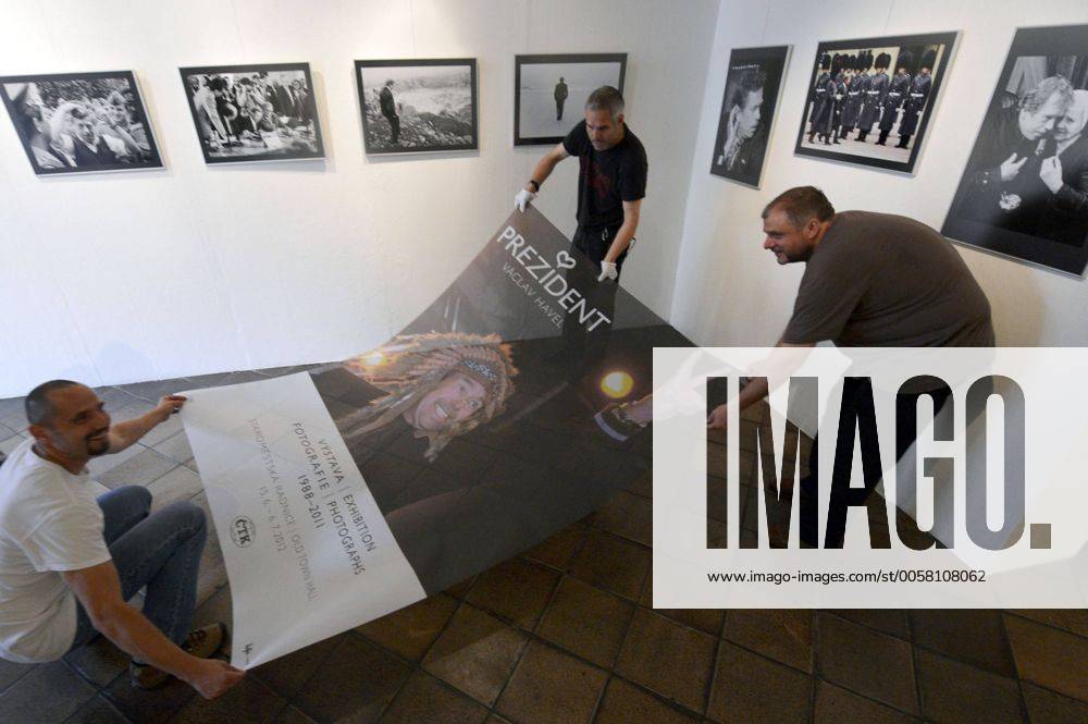 CTK Photobank Editor in Chief Petr Mlch (left to right) and photographers Michal Kamaryt and Stanislav Zbynek pose with the poster before the exhibition President Vaclav Havel opening in Prague Thursday, June 14, 2012. Photographs of Vaclav Havel (1936-2011) taken by CTK reporters, mainly from the time of his presidency, are displayed in Prague s Old Town Hall. (CTKxPhoto RomanxVondrous) CTKPhoto031201206140684401
