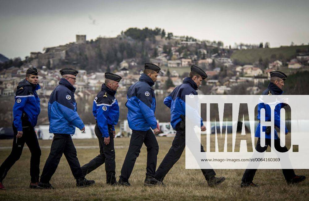 (150325) -- SEYNE, March 25, 2015 -- French gendarmes walk in the rescue base camp in the Alps in southern France, March 25, 2015. French gendarmes late Tuesday found one of the two black boxes of the German passenger plane that crashed in southern France with 150 people on board, while a joint international probe into the cause of the accident is under way. ) FRANCE-SEYNE-AIRBUS A320 CRASH-RESCUE ChenxXiaowei
