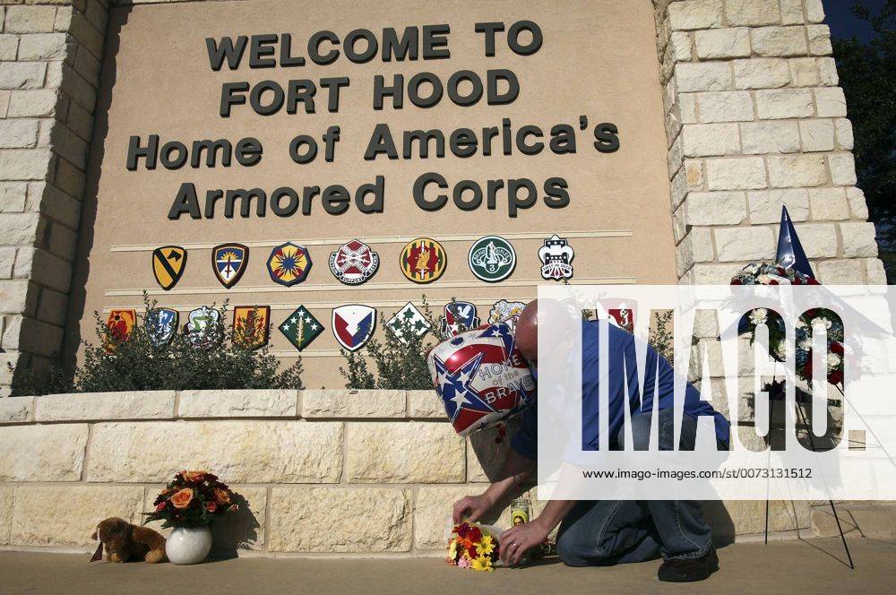 FOR METRO - U.S. Army Spc. Ryan Hill lays flowers near the main entrance to Fort Hood Army Post Saturday Nov. 7, 2009 in Fort Hood, Tx. PHOTO BY EDWARD A. ORNELAS eaornelas@express-news.net) - ZUMAa27_