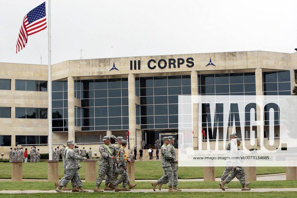 FOR METRO - U.S. Army soldiers pass III Corps headquarters where an American flag flies at half staff on Fort Hood Army Post Monday Nov. 9, 2009 in Fort Hood, Tx. PHOTO BY EDWARD A. ORNELAS eaornelas@express-news.net) - ZUMAa27_