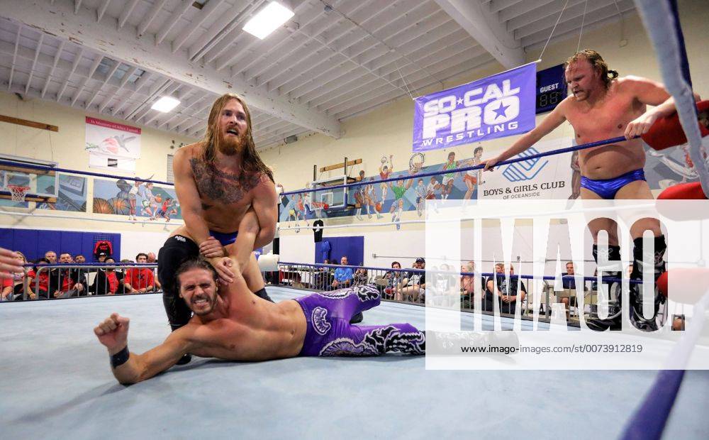Oceanside, California, USA - 10 15 2016_Oceanside, CA_SoCal Pro Wrestling s Rumble in Oceanside event at the Oceanside Boys & Girls Club gymnasium. Wrestler Mike Camden twists the arm of opponent Ricky Mandel as Mandel s tag-team partner Tommy Wilson watches._Photo by Oceanside USA - ZUMAn47_