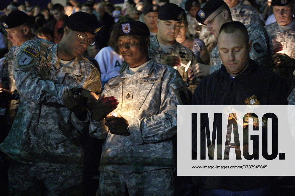 Fort Hood Shooting Maj. William McKnight, left, Sgt. Maj. Leroy Walker, Jr., and Com. Sgt. Maj. Ted Pritchard hold candles during a candlelight vigil held in Hood Stadium at Fort Hood, Texas, Friday, November 6, 2009. (Ron T. Ennis Fort Worth Star-Telegram MCT) FORT HOOD TX US