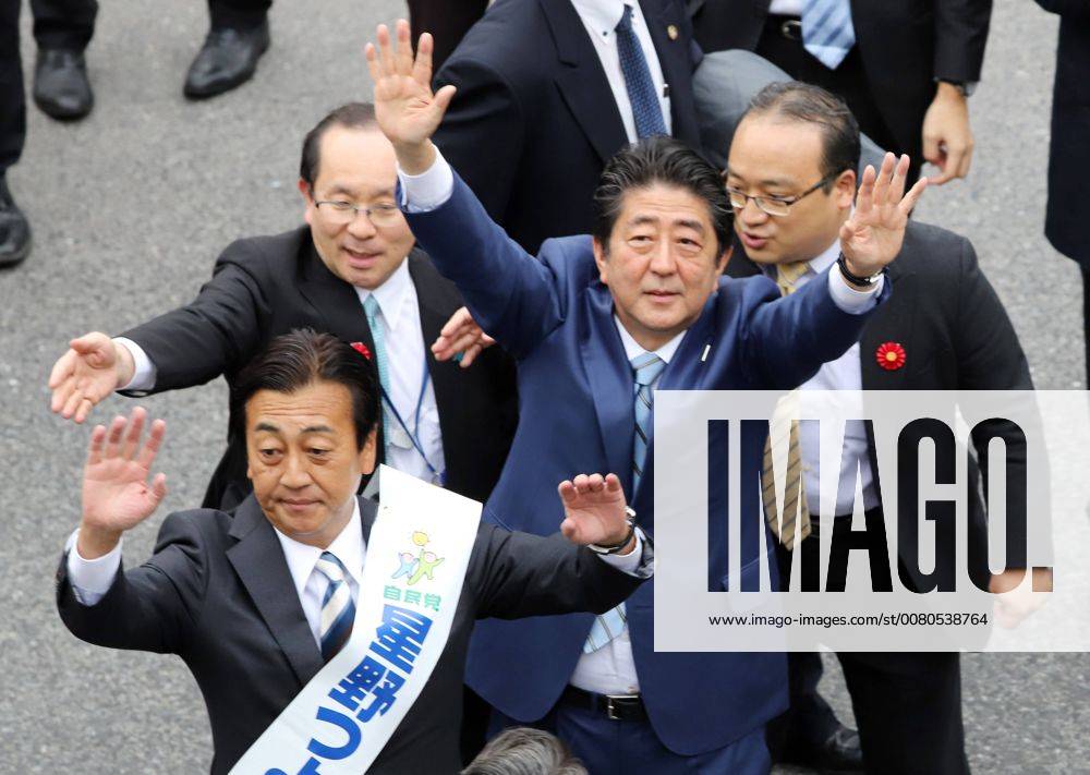Tokyo, Japan - Japanese Prime Minister and ruling LDP leader Shinzo Abe (R) and his party candidate Tsuyoshi Hoshino wave to their supporters at an election campaign in Fujisawa, suburban Tokyo on Friday, Octoebr 20, 2017. Japan s general election will be held on October 22. (lwxa014883)