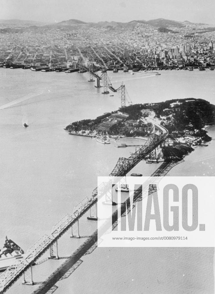 World s longest bridge nears completion . An aerial view of the San Francisco Oakland Bay bridge , which is nearing completion . Yerba Buena Island , through which the bridge is tunnelled , is in centre , and beyond is San Francisco . 16 April 1936, San Francisco California United States of America