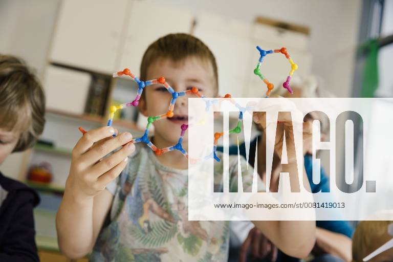 Boy holding dna helix model in kindergarten model released Symbolfoto property released MFF04128