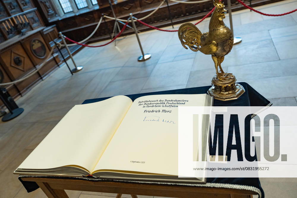 Federal Chancellor Friedrich Merz signs the Golden Book of the City of Münster in the Peace Hall, view of the Golden Book with the Federal Chancellors signature and the traditional Golden Rooster of the City of Münster Inaugural visit of the Federal Chancellor to North Rhine-Westphalia Münster , Münster North Rhine-Westphalia Germany City Hall
