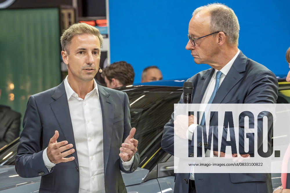 Federal Chancellor Friedrich Merz in conversation with Opel CEO Florian Huettl, tour of the trade fair at the opening of the IAA Mobility 2025, Messe München, September 9, 2025 Germany, Munich, September 9, 2025, Federal Chan