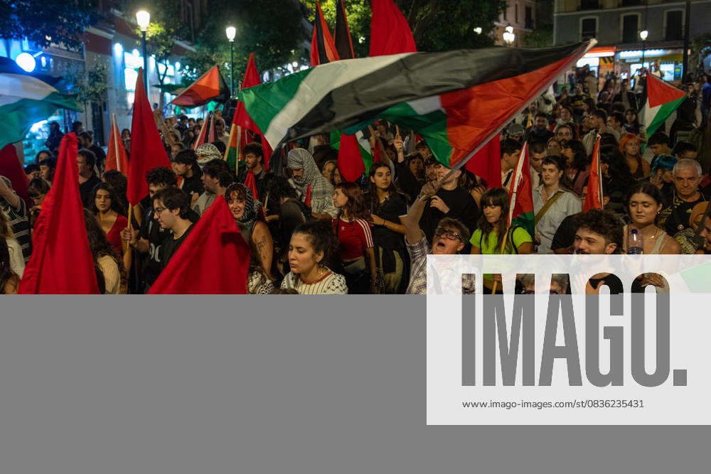 Protesters hold Palestinian flags during a pro-Palestinian demonstration in the LavapiÃ s neighborhood of Madrid. Madrid Spain - ZUMAs197 20251003_aaa_s197_533