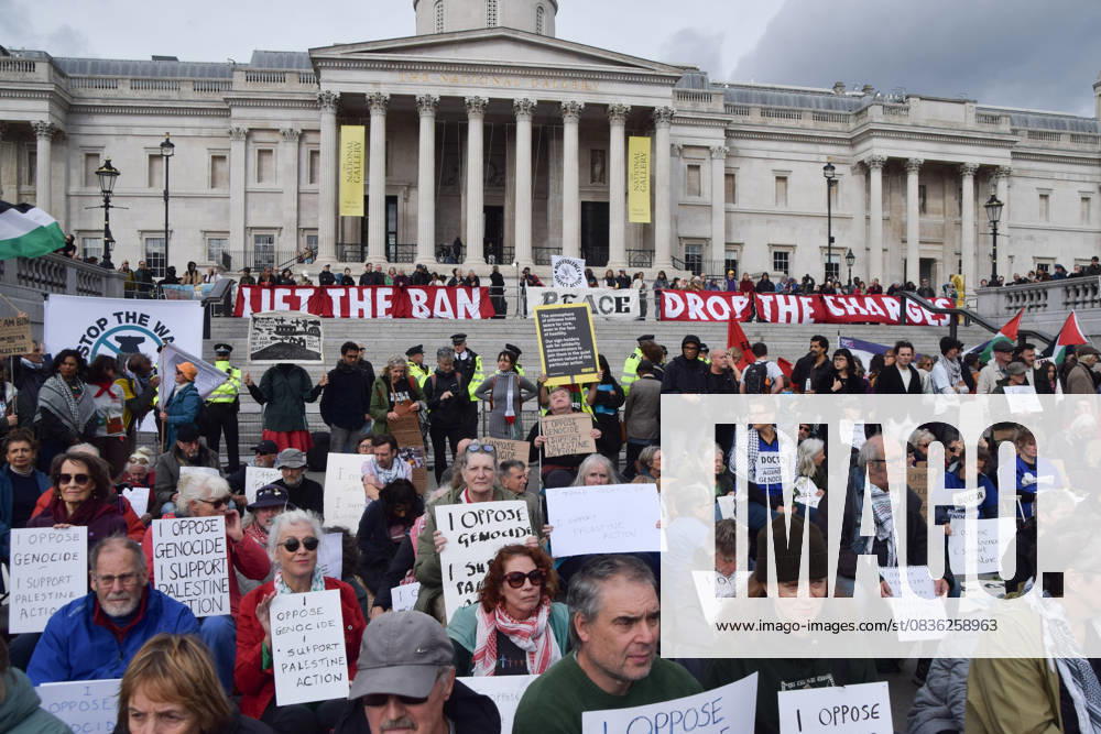 Protesters hold placards stating I Oppose Genocide, I Support Palestine Action during the demonstration in Trafalgar Square. Hundreds of people gathered to show support for the activist group Palestine Action, which has been banned under anti-terrorism law, and demanded that the ban is lifted. London United Kingdom - ZUMAs197 20251004_aaa_s197_242