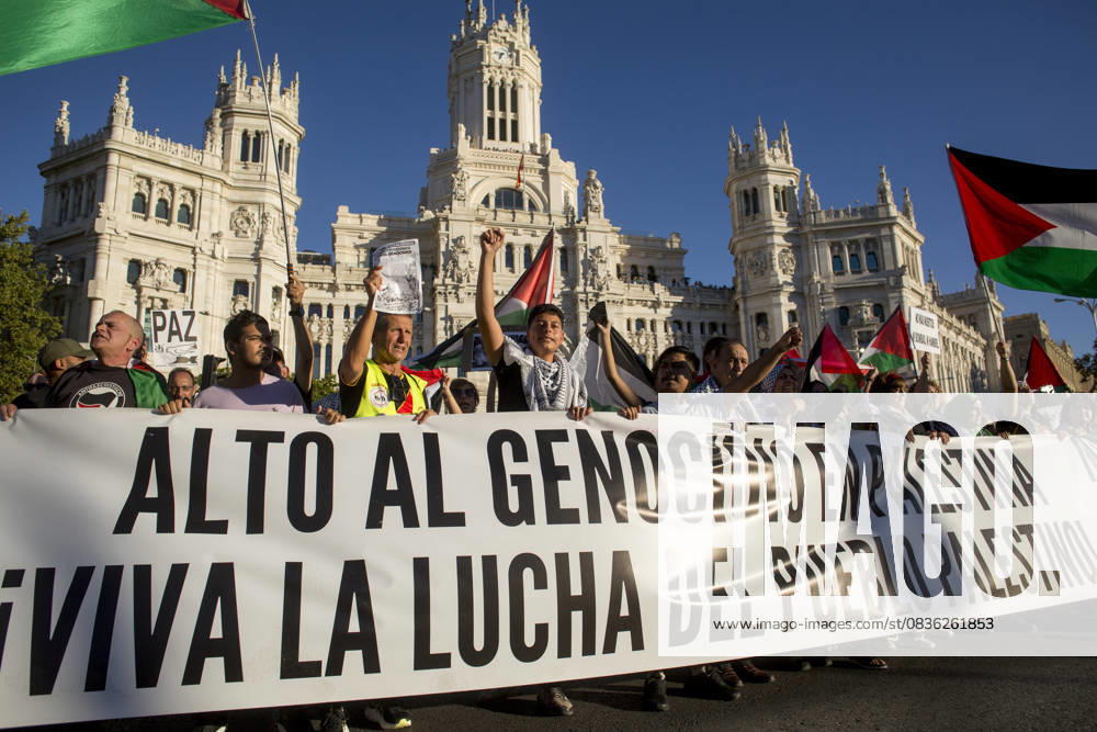 Protesters hold the banner at the top, with the Cibeles Palace visible behind them, during a pro-Palestinian demonstration in central Madrid in solidarity with the Palestinian people in the face of Israeli attacks and condemning the interception by Israeli forces of the Global Sumud Flotilla ships. Madrid Spain - ZUMAs197 20251004_aaa_s197_295