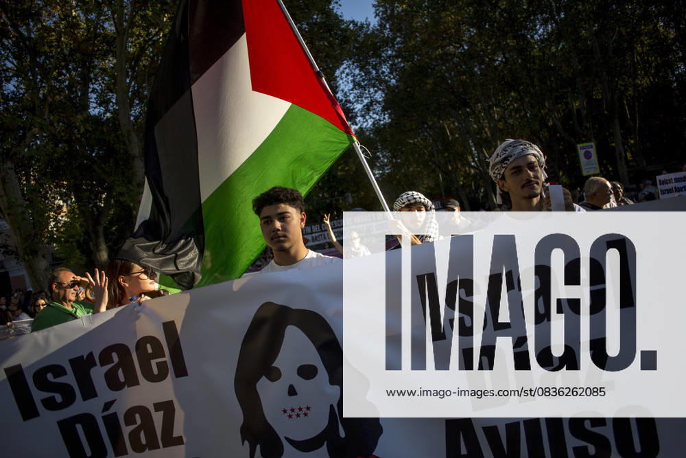 Protesters hold a banner saying Israel Diaz Ayuso in Spanish, referring to the president of the Community of Madrid, during a pro-Palestinian demonstration in central Madrid in solidarity with the Palestinian people in the face of Israeli attacks and condemning the interception by Israeli forces of the Global Sumud Flotilla ships. Madrid Spain - ZUMAs197 20251004_aaa_s197_298