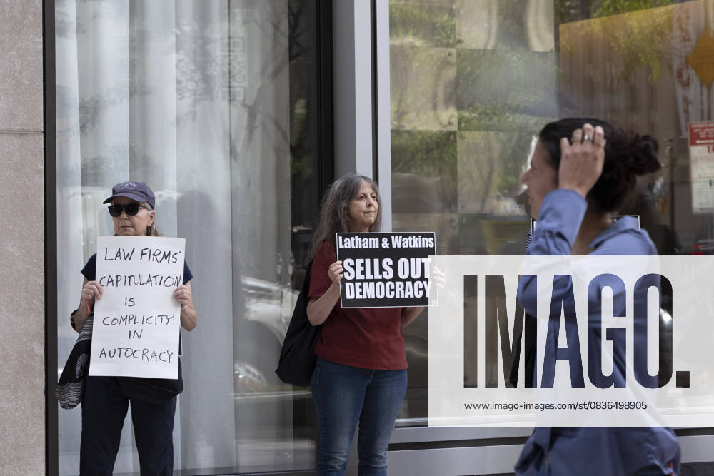 Demonstrators with the activist group Rise and Resist hold signs that read LAW FIRMS CAPITULATION IS COMPLICITY IN AUTOCRACY Latham and Watkins SELLS OUT DEMOCRACY outside of the offices of Latham and Watkins LLP in midtown Manhattan as lunchtime crowds pass. Protesters stage a peaceful demonstration denouncing the law firm s agreement to provide millions in pro bono legal work to initiatives from President Trumpâ€⠢s agenda and to abandon diversity, equity, and inclusion (DEI) policies. New York USA - ZUMAr174 20251007_znp_r174_035
