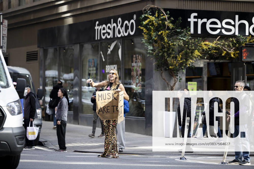 A protester holds a sign. Demonstrators fill streets across cities and towns nationwide during the Ã¢â‚¬oeNo KingsÃ¢â‚¬Â protest, denouncing the policies of the Trump administration. New York USA - ZUMAh182 20251018_znp_h182_011