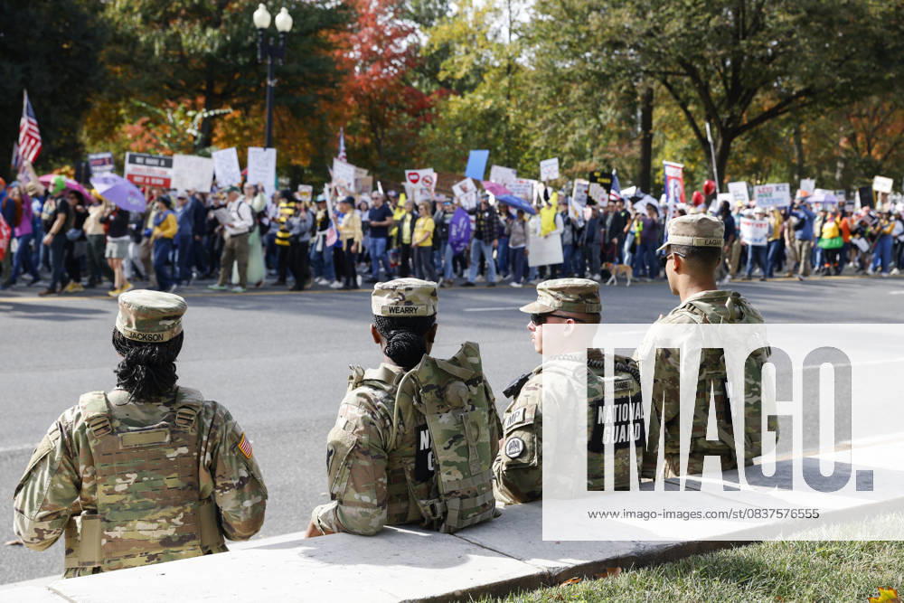 National Guard members are seen while demonstrators take part in a protest against the Donald Trump administration during the No Kings national rally on October 18, 2025, in Washington, DC, USA. Millions of people across the nation joined the No Kings protest to demonstrate their disapproval of the current US administration. The No Kings Day of Defiance has been organized to reject authoritarianism, billionaire-first politics, and the militarization of the countryâ€⠢s democracy, according to a statement by organizers. Washington Dc USA - ZUMAk203 20251018_znp_k203_016