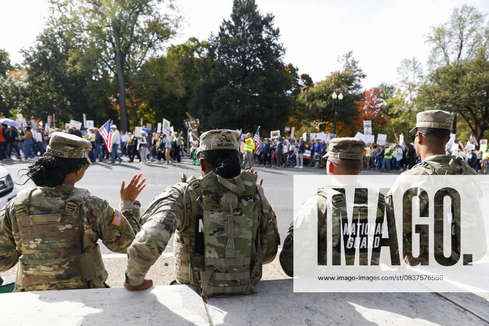 National Guard members are seen while demonstrators take part in a protest against the Donald Trump administration during the No Kings national rally on October 18, 2025, in Washington, DC, USA. Millions of people across the nation joined the No Kings protest to demonstrate their disapproval of the current US administration. The No Kings Day of Defiance has been organized to reject authoritarianism, billionaire-first politics, and the militarization of the countryÃ¢â‚¬â ¢s democracy, according to a statement by organizers. Washington Dc USA - ZUMAk203 20251018_znp_k203_017
