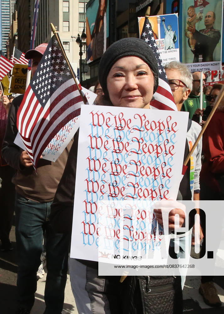 A woman holds a sign that says We the People during the No Kings protest in New York City on Oct. 18, 2025. Tens of thousands of people hit New York City streets to protest Donald Trump, autocracy, ICE and immigrant deportations. More than 2,500 similar protests took place nationwide. New York City USA - ZUMAk45_ 20251018_zaf_k45_044
