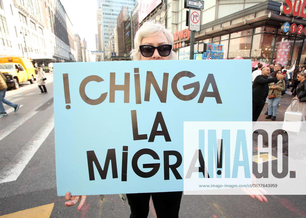 A woman holds a sign that says in Spanish, Chinga La Migra during the No Kings protest in New York City on Oct. 18, 2025. Tens of thousands of people hit New York City streets to protest Donald Trump, autocracy, ICE and immigrant deportations. More than 2,500 similar protests took place nationwide. New York City USA - ZUMAk45_ 20251018_zaf_k45_056