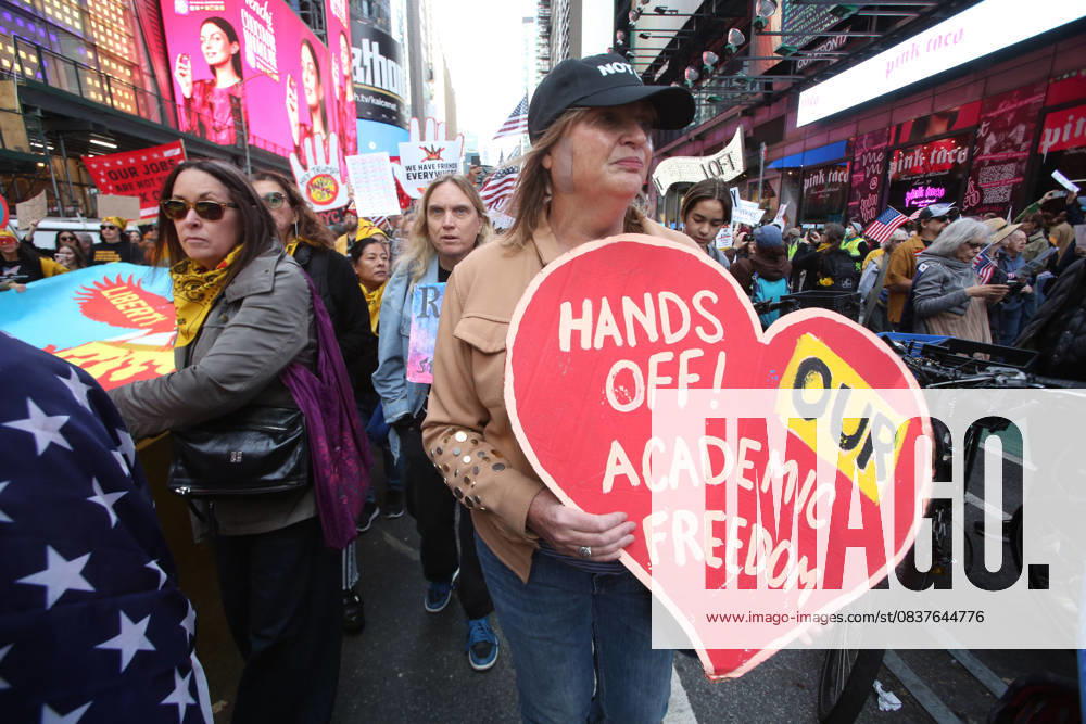 A woman holds a sign that says, Hands Off! Our Academic Freedom during the No Kings protest in New York City on Oct. 18, 2025. Tens of thousands of people hit New York City streets to protest Donald Trump, autocracy, ICE and immigrant deportations. More than 2,500 similar protests took place nationwide. New York City USA - ZUMAk45_ 20251018_zaf_k45_059