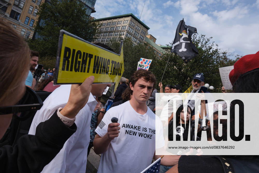 A protester holds up a yellow arrow that reads, â€oeRight Wing Troll†pointed towards right wing social media influencer, Nick Shirley wearing a Turning Point tee shirt with the phrase, â€oeAwake Is The New Woke†who is attempting to engage people who attended the New York City No Kings protest with MAGA talking points to solicit reactions for a livestream video in Union Square. New York USA - ZUMAl171 20251019_znp_l171_002