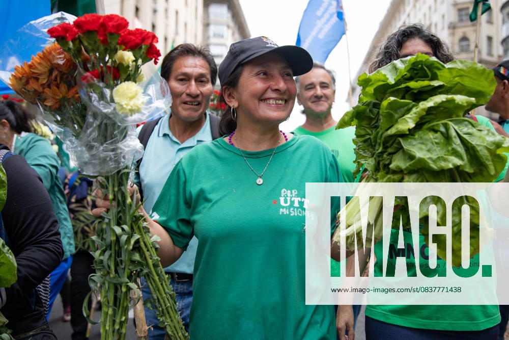A Farmer Poses Holding Flowers and Vegetables. On the march to Plaza de Mayo, she carries fresh food as a symbol of protest against the production and consumption crisis. Buenos Aires Argentina - ZUMAp265 20251016_zip_p265_001