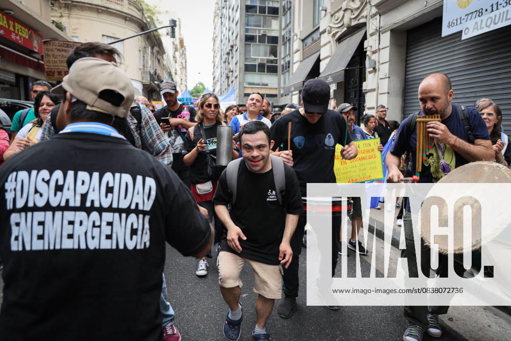 A young man with Down syndrome dances accompanied by musicians during the demonstration calling for enforcement of the Disability Emergency Law. Buenos Aires Argentina - ZUMAp265 20251022_zip_p265_002