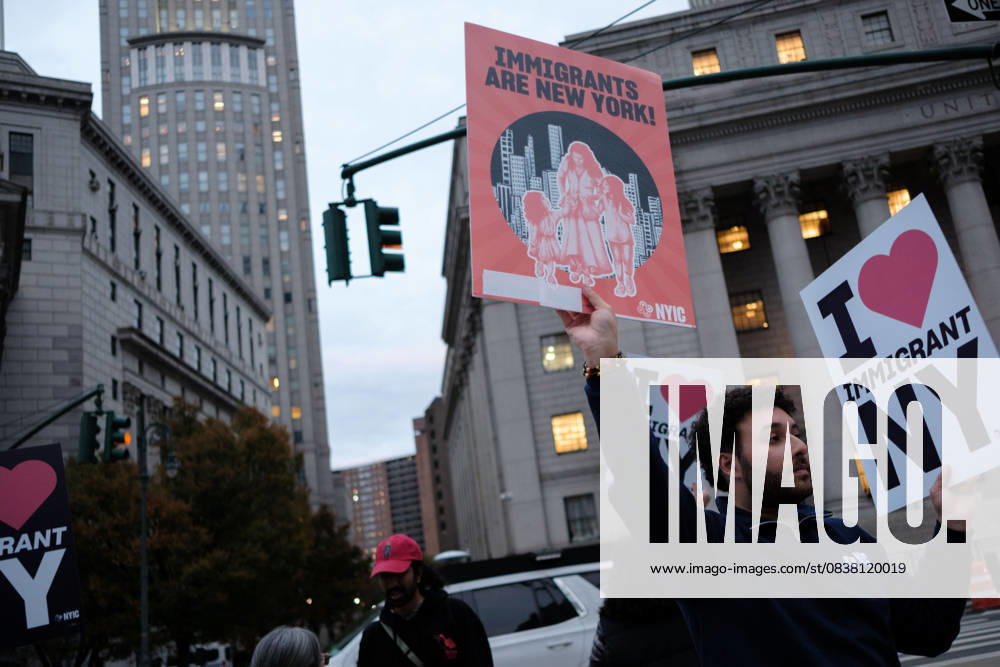 A protester holds signs saying Ã¢â‚¬oeImmigrants are New YorkÃ¢â‚¬Â and Ã¢â‚¬oeI Love Immigrant NYÃ¢â‚¬Â during a demonstration at Foley Square, in New York, on Wednesday, Oct. 22, 2025. This response comes after more than 50 federal agents arrested immigrant vendors at Canal Street, lower Manhattan, on Tuesday. New York USA - ZUMAs368 20251022_zip_s368_017