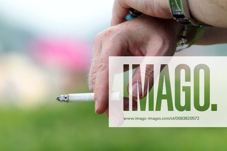 Hoppegarten Brandenburg GER Cigarette between the fingers of one hand Dependence on the outside Outdoor shot Brandenburg Detail