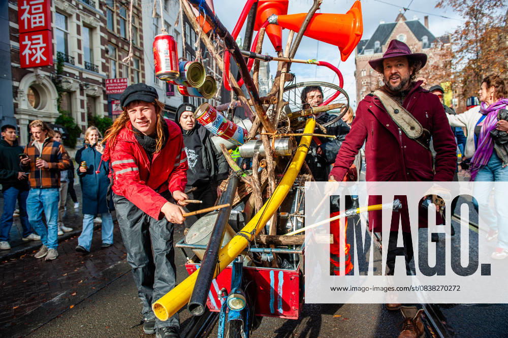 People are seen playing homemade instruments placed on a bike. ADEV (Amsterdam Danst Ergens Voor), in English Amsterdam Dances For A Cause , organized for the 13th time its annual demonstration for squatting, free spaces, and affordable housing in the city. People danced, accompanied by large trucks and loud music systems, to reclaim more free spaces in the city. Amsterdam Netherlands - ZUMAs197 20251025_aaa_s197_451
