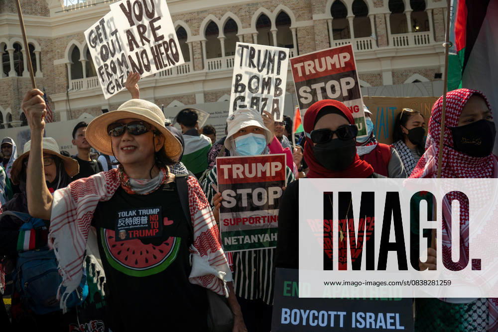 Protesters hold placards during a protest against US President Donald Trump s visit for the Association of Southeast Asian Nations (ASEAN) 47th ASEAN Summit in Kuala Lumpur. Kuala Lumpur Malaysia - ZUMAr146 20251026_zap_r146_002