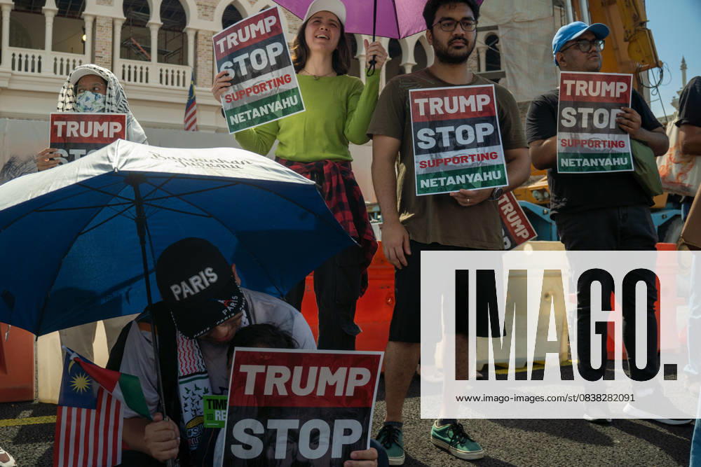 Protesters hold placards during a protest against US President Donald Trump s visit for the Association of Southeast Asian Nations (ASEAN) 47th ASEAN Summit in Kuala Lumpur. Kuala Lumpur Malaysia - ZUMAr146 20251026_zap_r146_007