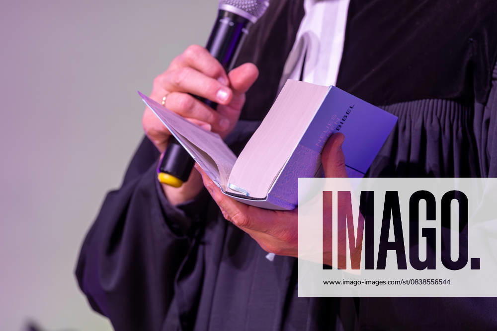 Protestant pastor holding a Bible in his hand Symbolic image church