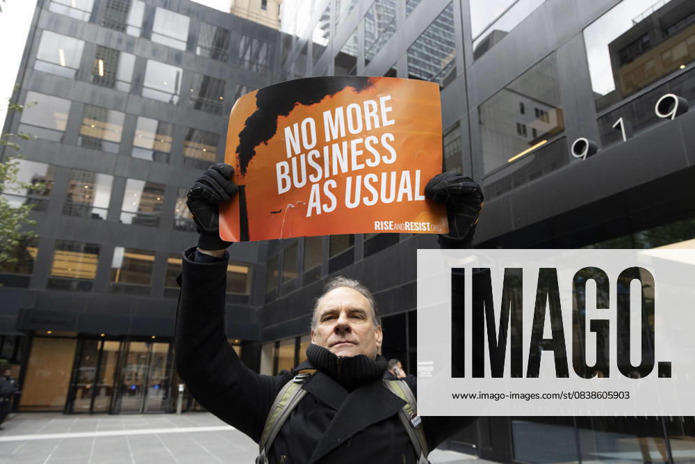 A demonstrator holds a sign that reads NO MORE BUSINESS AS USUAL with an image of a smokestack at a rally and picket against the Governor s recent climate policy announcement outside Hochul s New York City office in Midtown Manhattan. Climate activists say President Trump isn t a king and Governor Hochul isn t a Queen after she announced plans to delay the implementation of a state law set to begin January 1st that ends gas use in new construction. Demonstrators also denounce what they call the Governor s lurch to Trumpism for fast tracking the permitting for a fracked gas pipeline. The peaceful protest is organized by New York Communities For Change, Food and Water Watch NY and NYPIRG. New - ZUMAr174 20251028_znp_r174_006