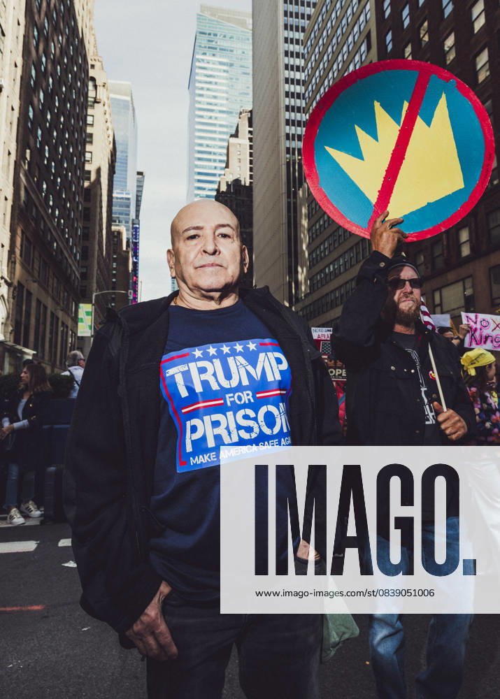 A demonstrator wearing a Trump for Prison tee shirt pauses while marching down Manhattan during a No Kings protest. An estimated 350,000 attended this event. New York USA - ZUMAp287 20251018_znp_p287_005
