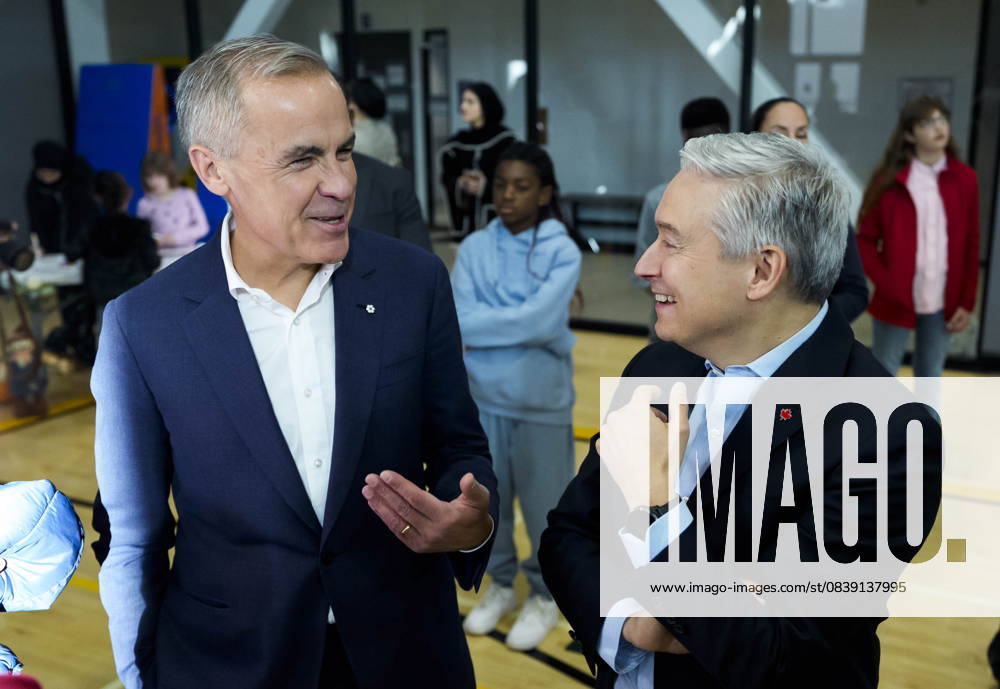 Ottawa, On, CAN: Prime Minister Mark Carney jokes with Minister of Finance and National Revenue Francois-Philippe Champagne as they greet families before participating in an announcement at a community centre in Ottawa, on Friday, Oct. 10, 2025. Ottawa CAN - ZUMAc35_ 20251010_zaf_c35_162