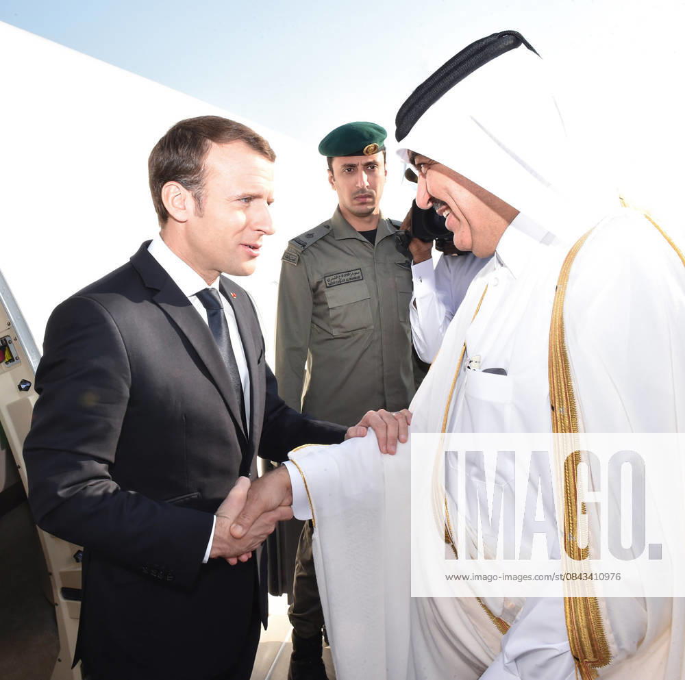 French President Emmanuel Macron in Qatar DOHA, QATAR - DECEMBER 7: (---- – MANDATORY CREDIT - QATAR EMIRATE COUNCIL HANDOUT - NO MARKETING NO ADVERTISING CAMPAIGNS - DISTRIBUTED AS A SERVICE TO CLIENTS----) French President Emmanuel Macron (L) is welcomed by Mohamed bin Abullah Al Rumaihi, Qatari Minister of Municipality and Environment upon his arrival at Hamad Airport in Doha, Qatar on December 7, 2017. Qatar World. Editorial use only. Please get in touch for any other usage.