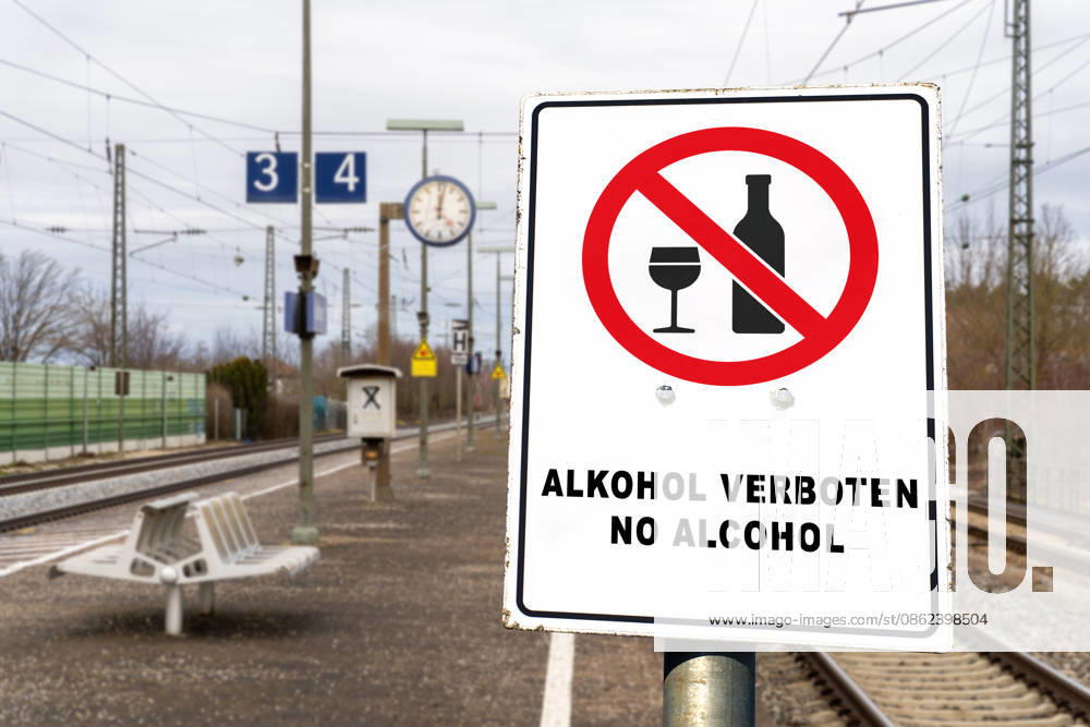 PHOTOMONTAGE, sign at the train station: ALCOHOL PROHIBITED, NO ALCOHOL. Deutsche Bahn (DB) is gradually implementing a nationwide ban on alcohol consumption at its train stations. The ban applies to platforms and station concourses, but not to food and beverage establishments