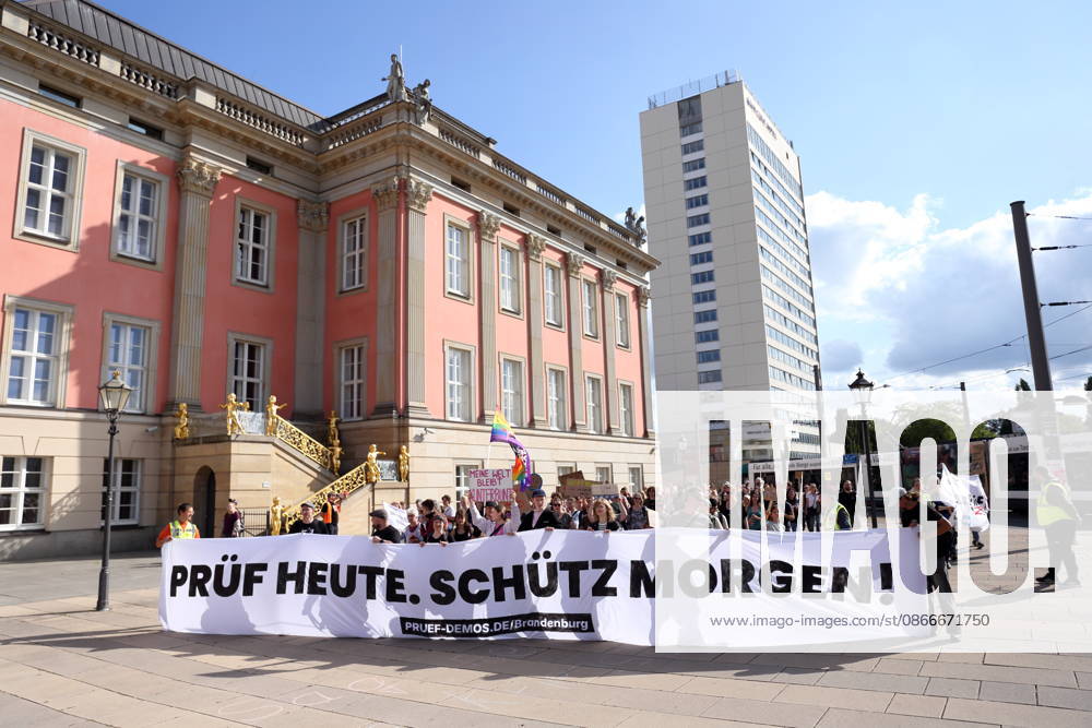 Protesters carrying a banner reading Review today, ban tomorrow march around the state parliament during a demonstration calling for the Federal Constitutional Court to review far-right parties, Alter Markt, Potsdam, September 12, 2026. Review Demonstration in Potsdam
